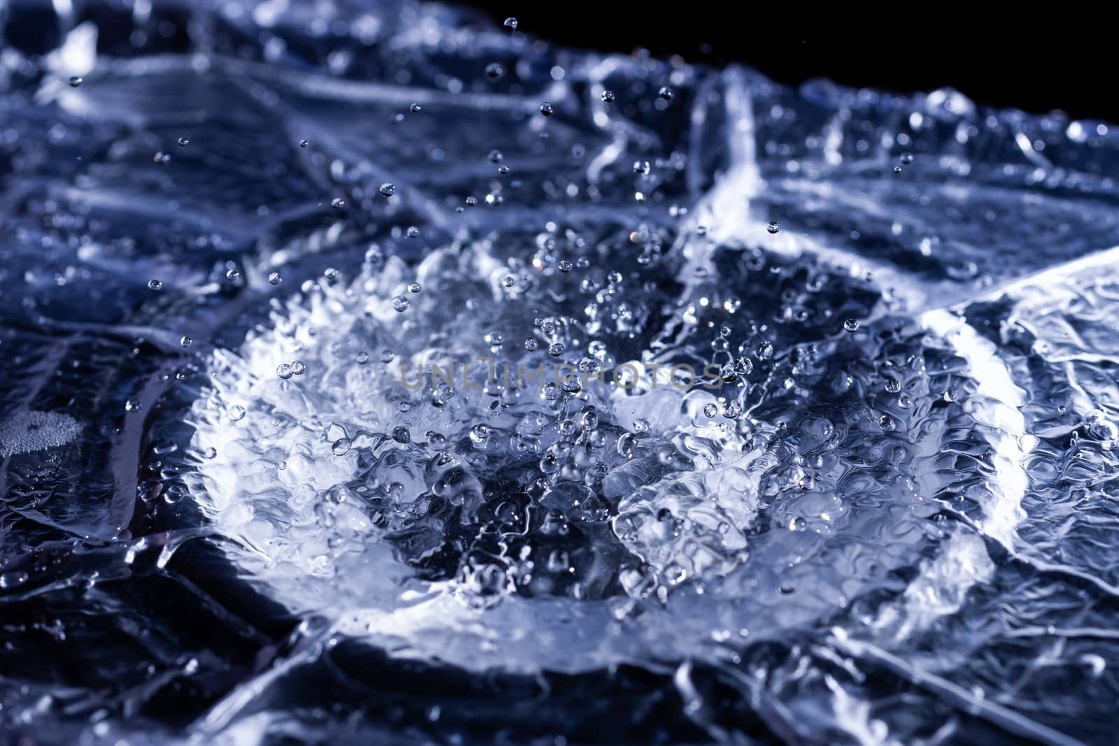 Water drops splashing on acoustic membrane. A lot of drops in air. High frequency of sound waves. Water cloud small drops. Frozen time shot.