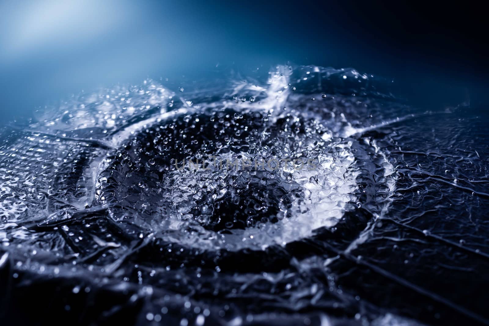 Water drops splashing on acoustic membrane. A lot of drops in air. High frequency of sound waves. Water cloud small drops. Frozen time shot.