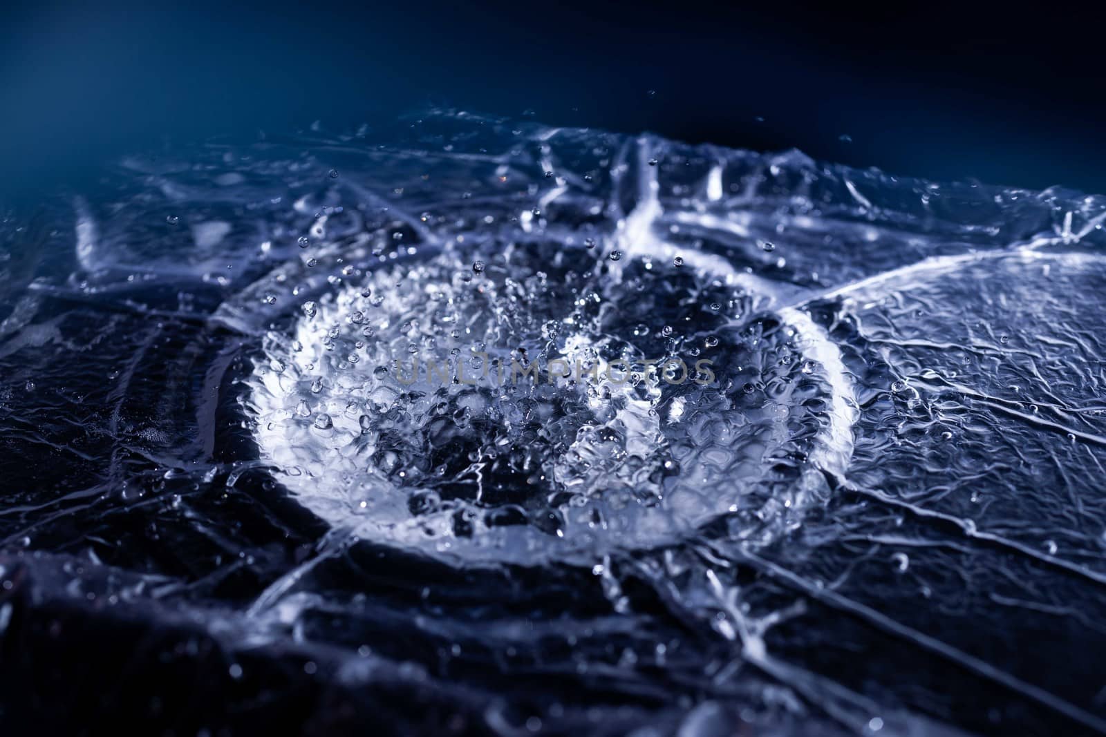 Water drops splashing on acoustic membrane. A lot of drops in air. High frequency of sound waves. Water cloud small drops. Frozen time shot.