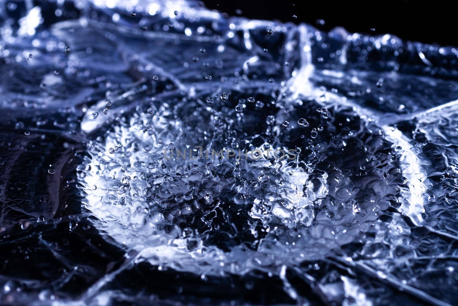 Water drops splashing on acoustic membrane. A lot of drops in air. High frequency of sound waves. Water cloud small drops. Frozen time shot. 