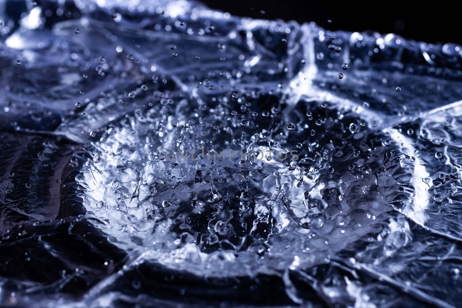 Water drops splashing on acoustic membrane. A lot of drops in air. High frequency of sound waves. Water cloud small drops. Frozen time shot.