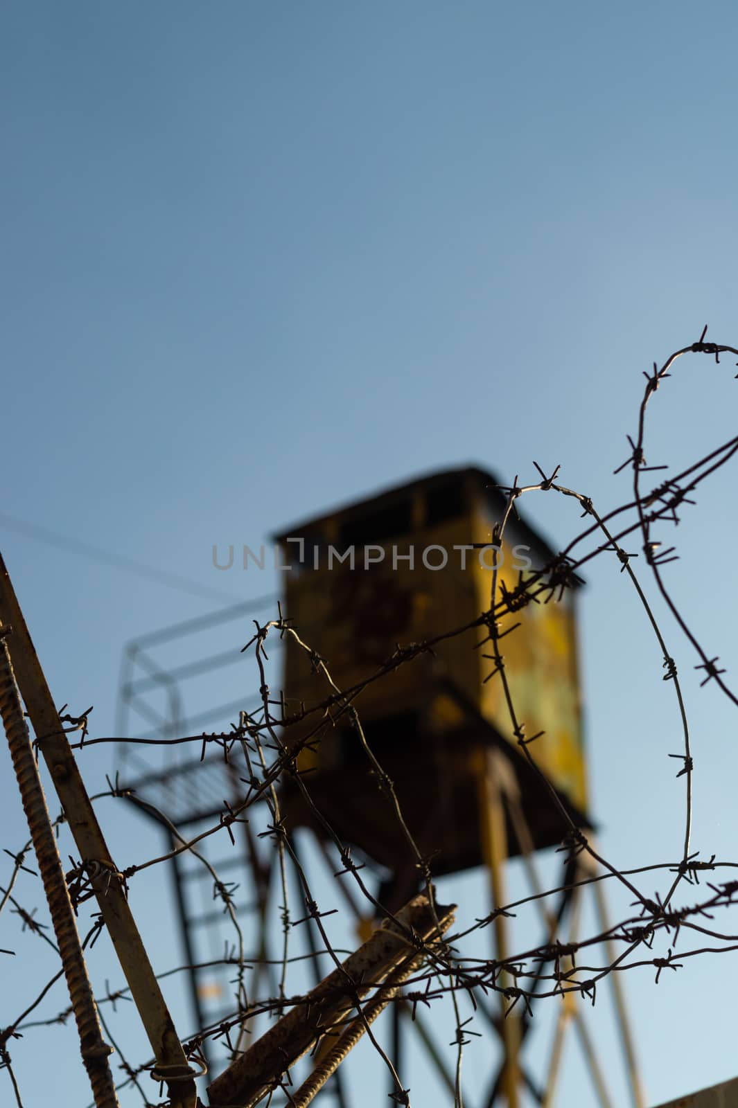 Barbed wire and watchtower of the military unit