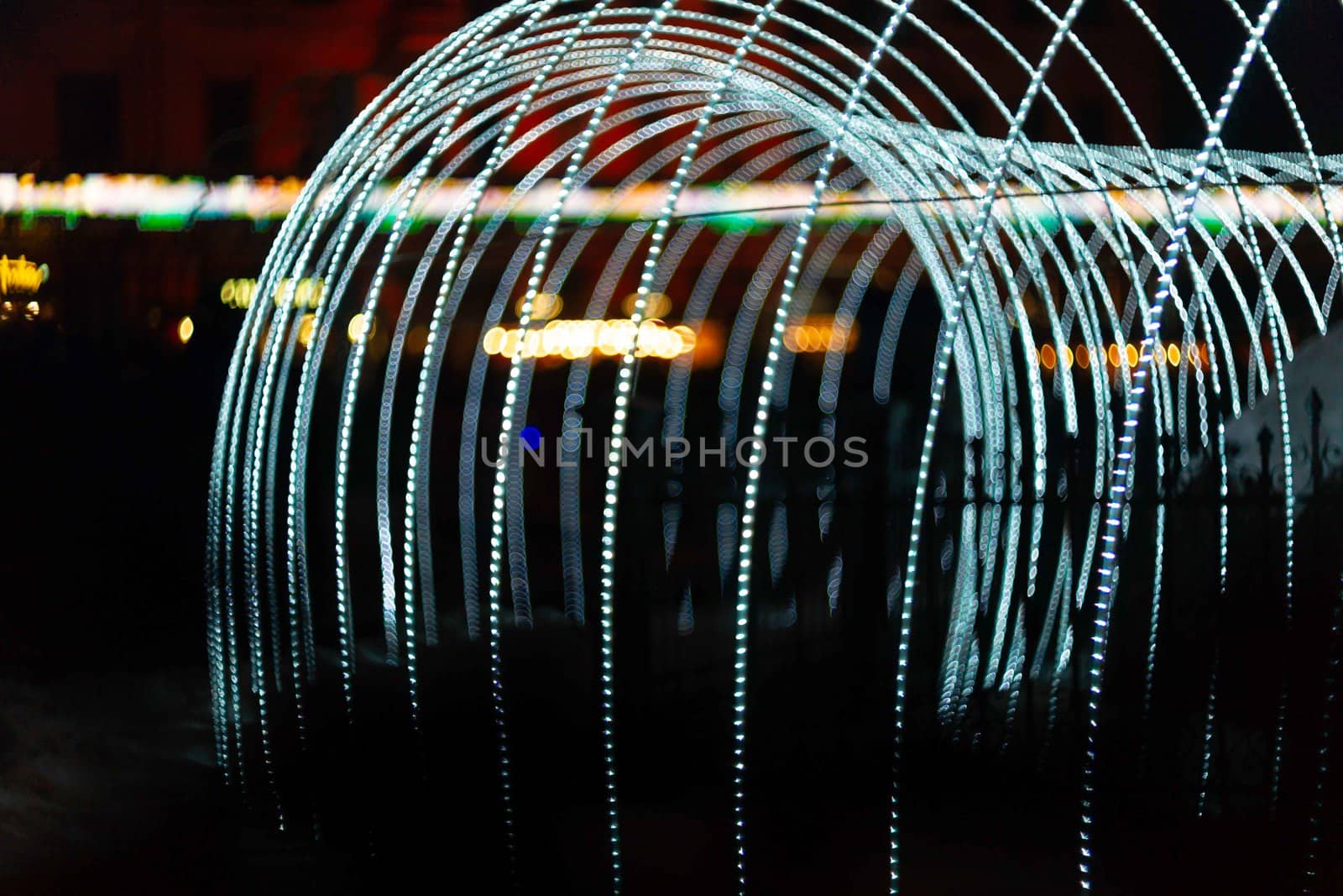 Vertical Christmas garland wall. Light is white and defocused. Blurred background, new year mood.