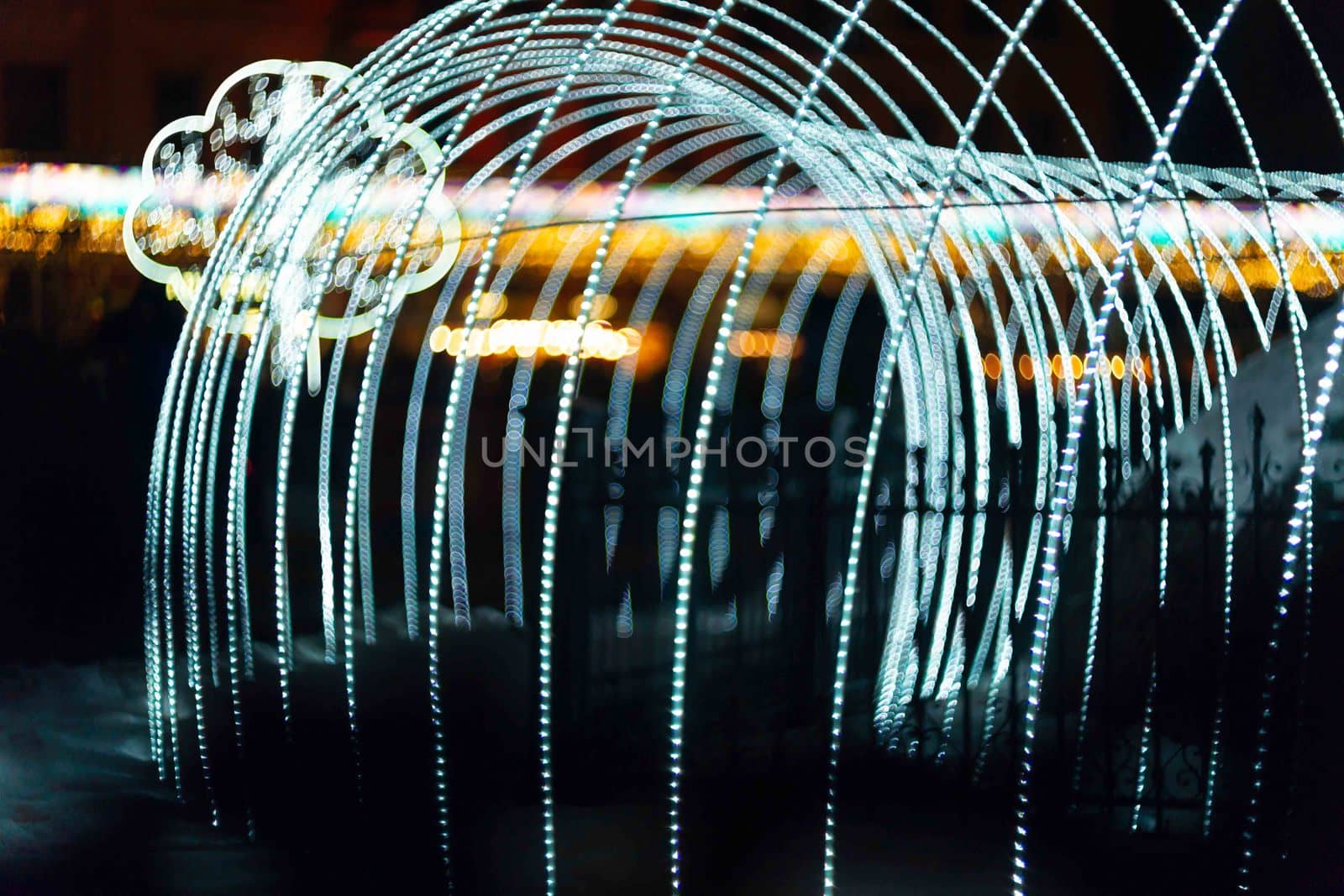 Vertical Christmas garland wall. Light is white and defocused. Blurred background, new year mood.