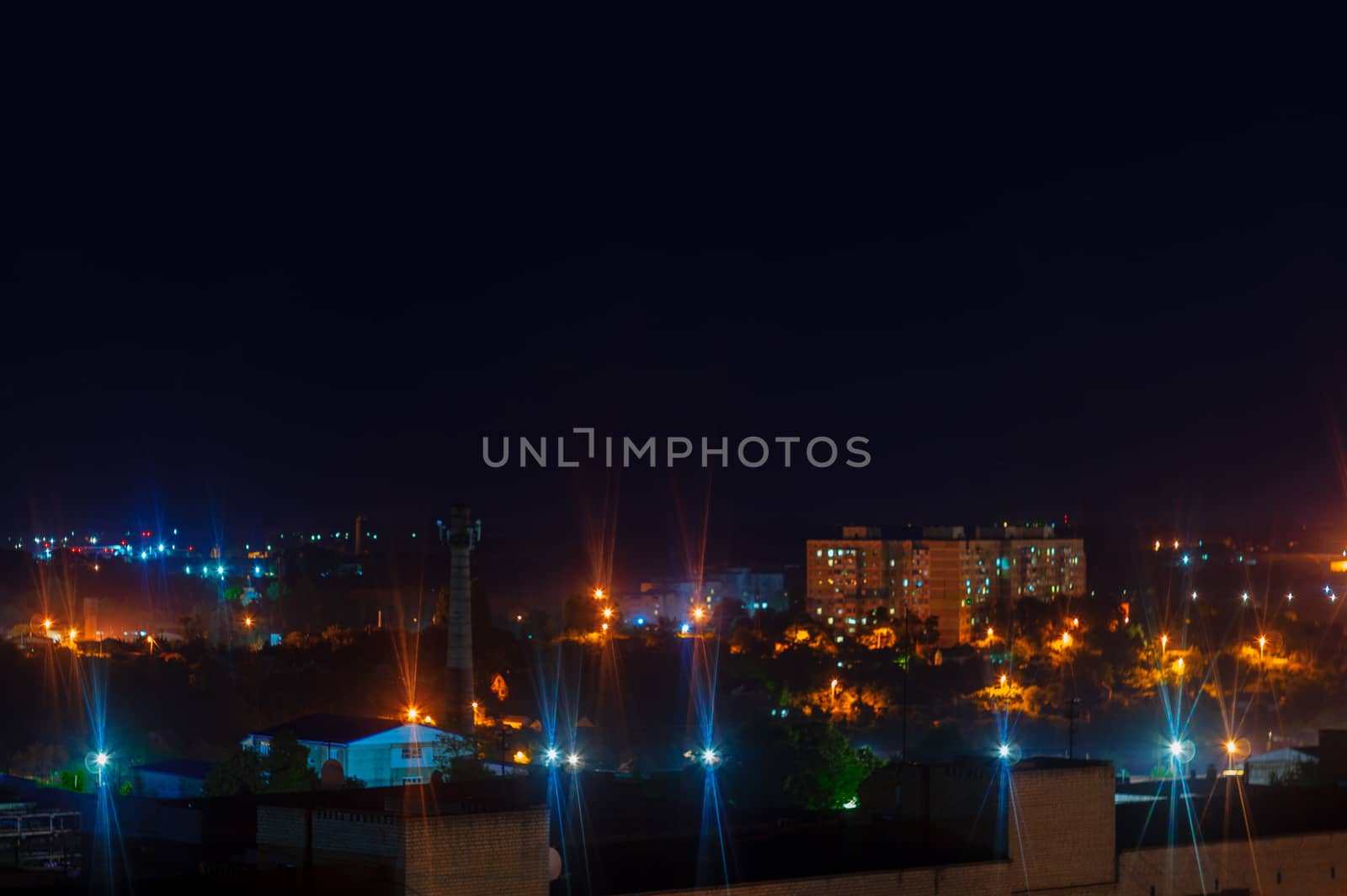 Long exposure night photo. A lot of stars with trees on foreground. Far from the city. Night landscape.