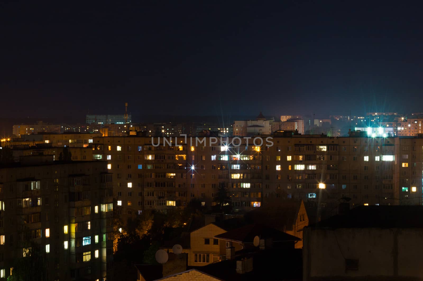 Long exposure photo big city life at night. High view above the city.