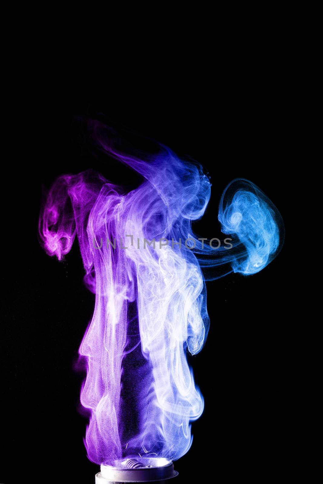 Colored clouds of vape smoke. A lot of colour and glicerine clouds, red and blue colours. Stock photo isolated on black background with boling spray of vaping liquid. Vape culture and no smoking movement.