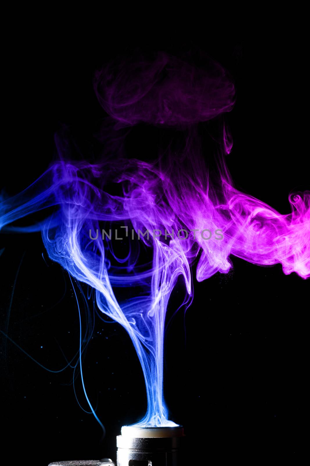 Colored clouds of vape smoke. A lot of colour and glicerine clouds, red and blue colours. Stock photo isolated on black background with boling spray of vaping liquid. Vape culture and no smoking movement.