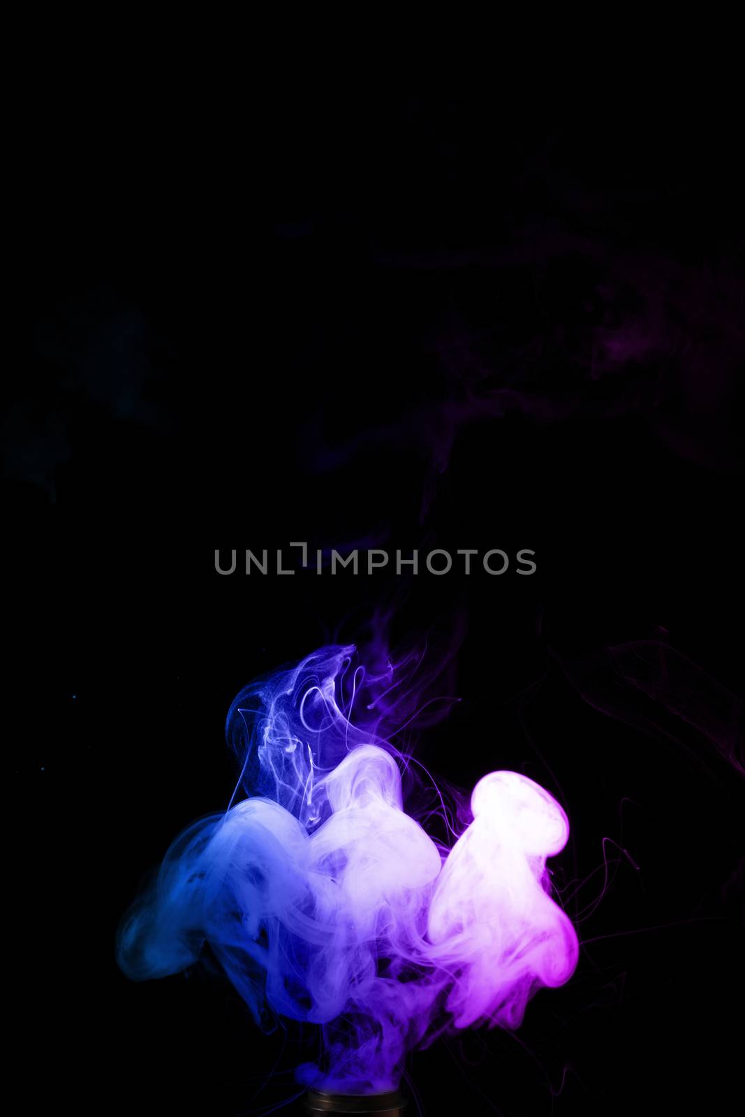 Colored clouds of vape smoke. A lot of colour and glicerine clouds, red and blue colours. Stock photo isolated on black background with boling spray of vaping liquid. Vape culture and no smoking movement.