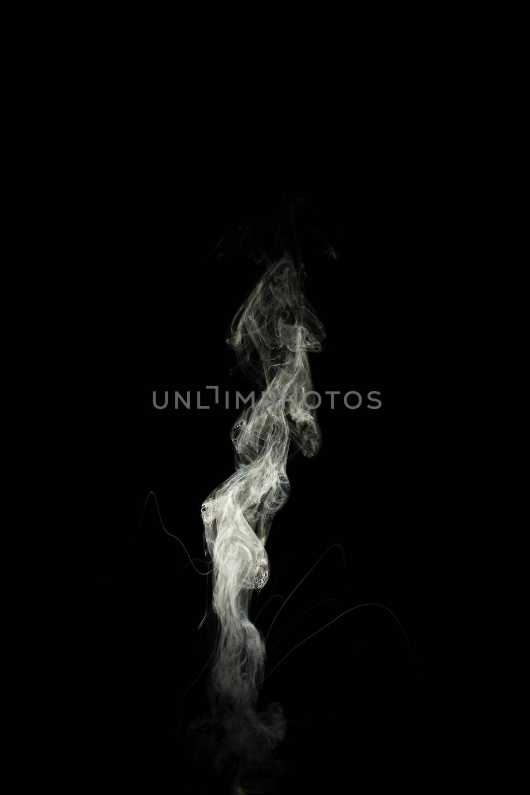 Vape steam column with spray boiling liquid. Stock photo isolated on black background.