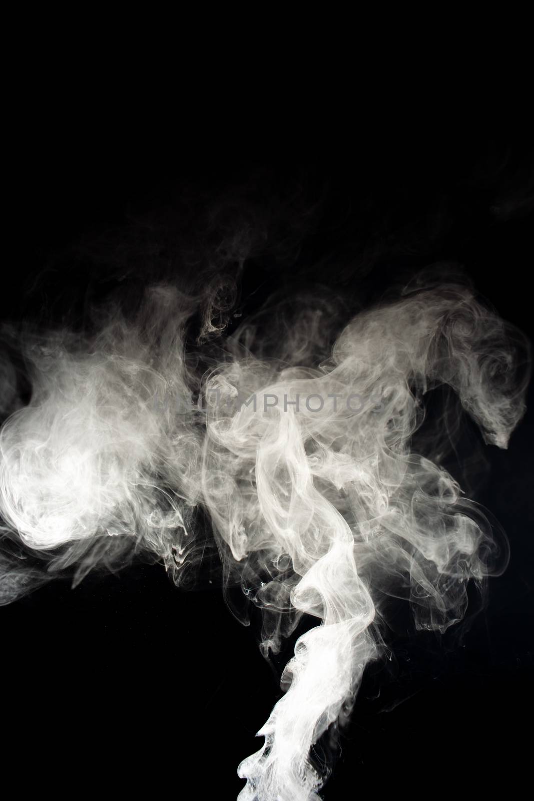 Vape steam spread with spray boiling liquid. Stock photo isolated on black background. Vape culture outreach. Conceptual image.