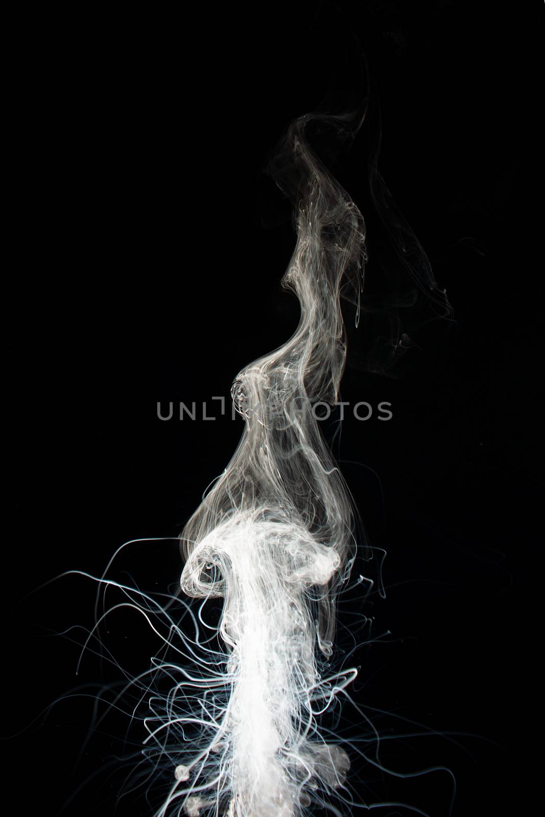 Column of vape clouds splash on black background. A lot of lines of smoke. White fog is tight. Stock isolated white smoke with spray boiling liquid.