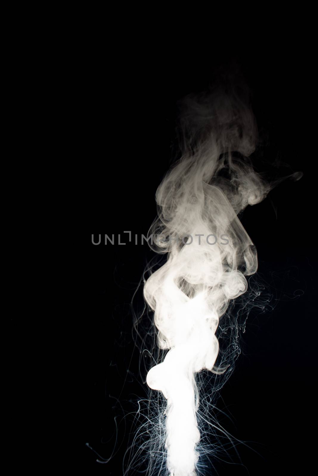 Column of vape clouds splash on black background. A lot of lines of smoke. White fog is tight. Stock isolated white smoke with spray boiling liquid.