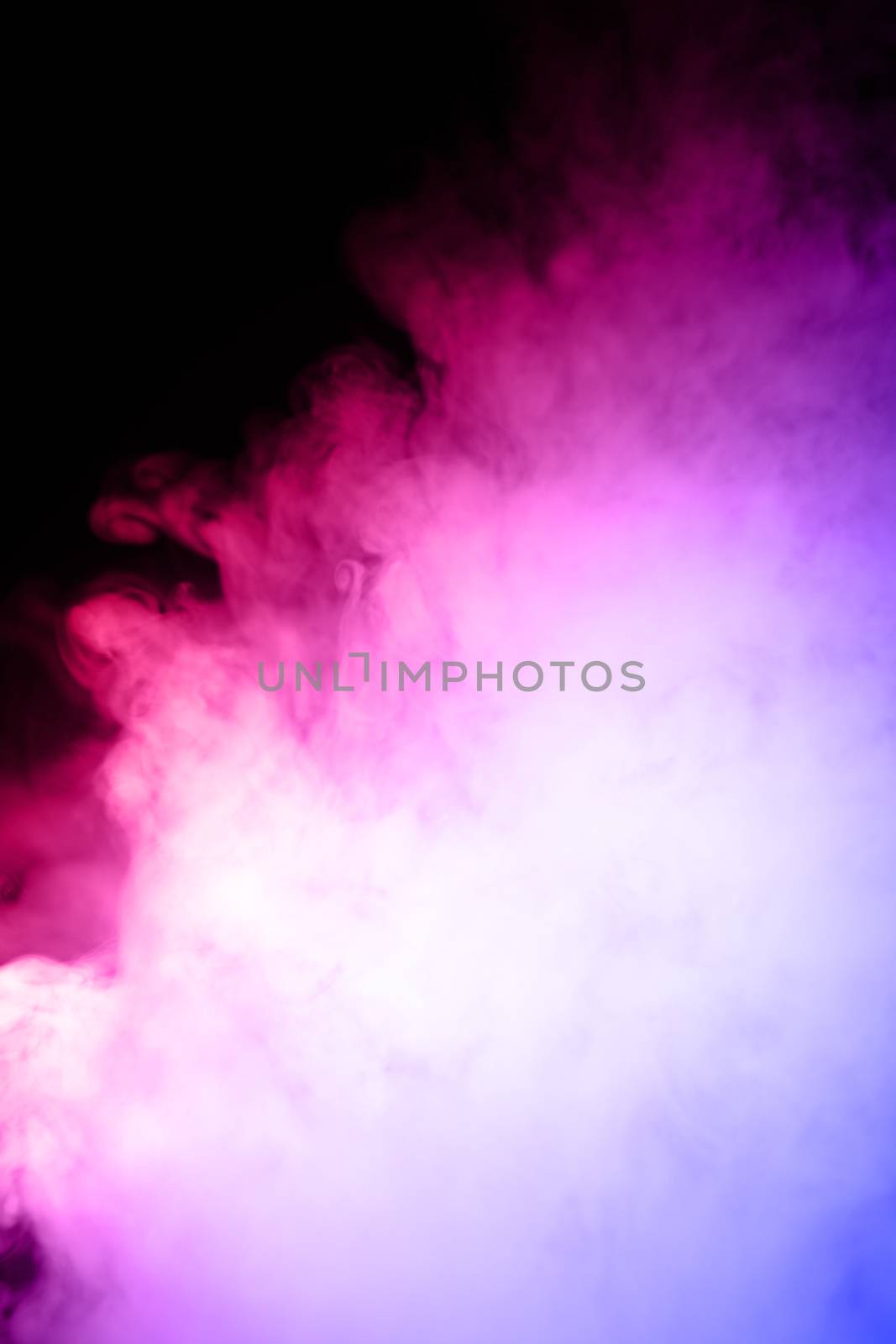 Сlouds of vape fog on black background. At right side thick smoke rising up. Bicolor blue and red steam in frame. Vape culture and no smoking direction..