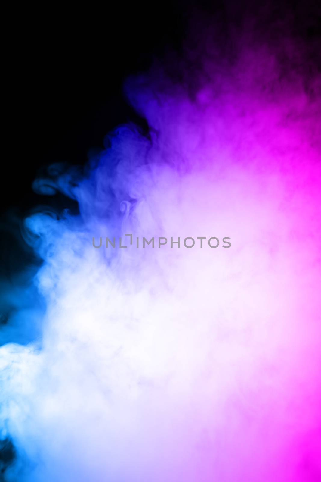 Сlouds of vape fog on black background. At right side thick smoke rising up. Bicolor blue and purple steam in frame. Vape culture and no smoking direction..
