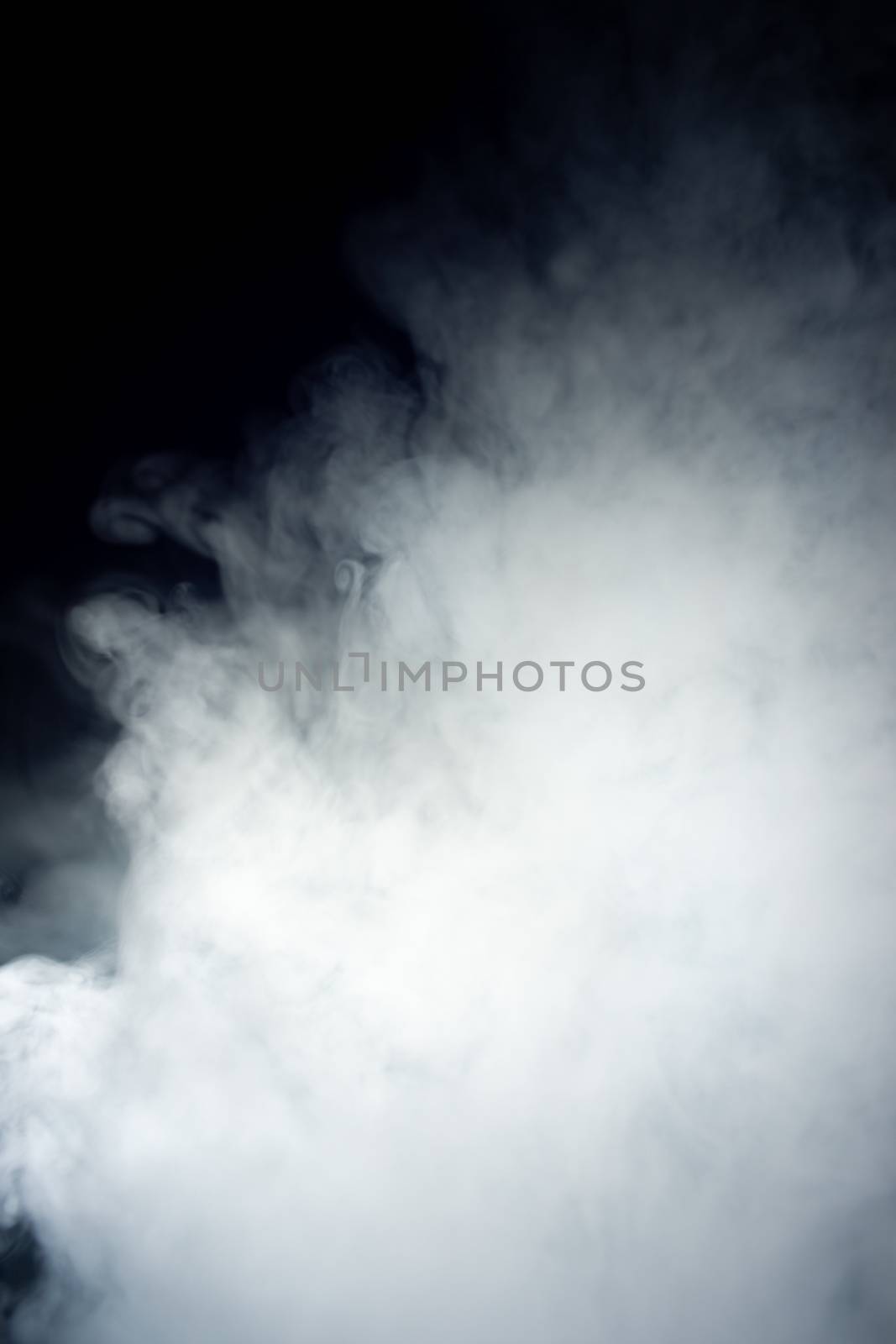 Сlouds of vape fog on black background. At right side thick smoke rising up. Vape culture and no smoking movement.