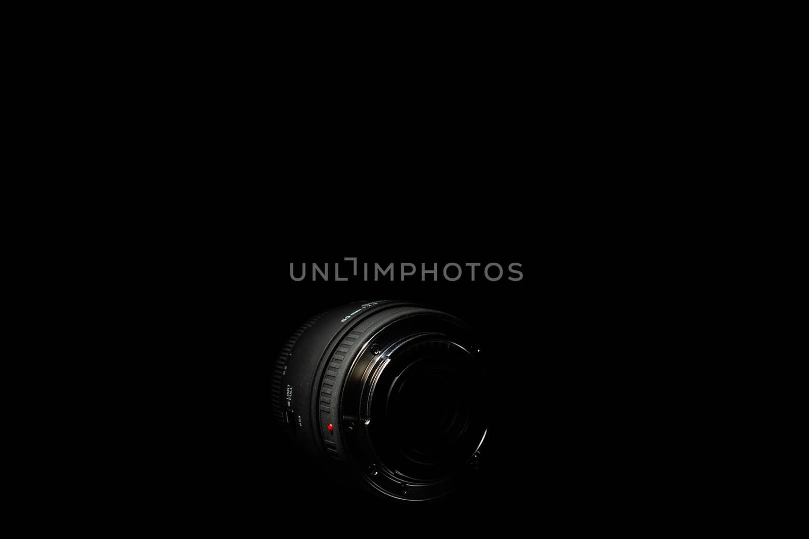 Underexposed photo of DSLR lens. Stock photo isolated on black background. Low light photo. A large depth of field.