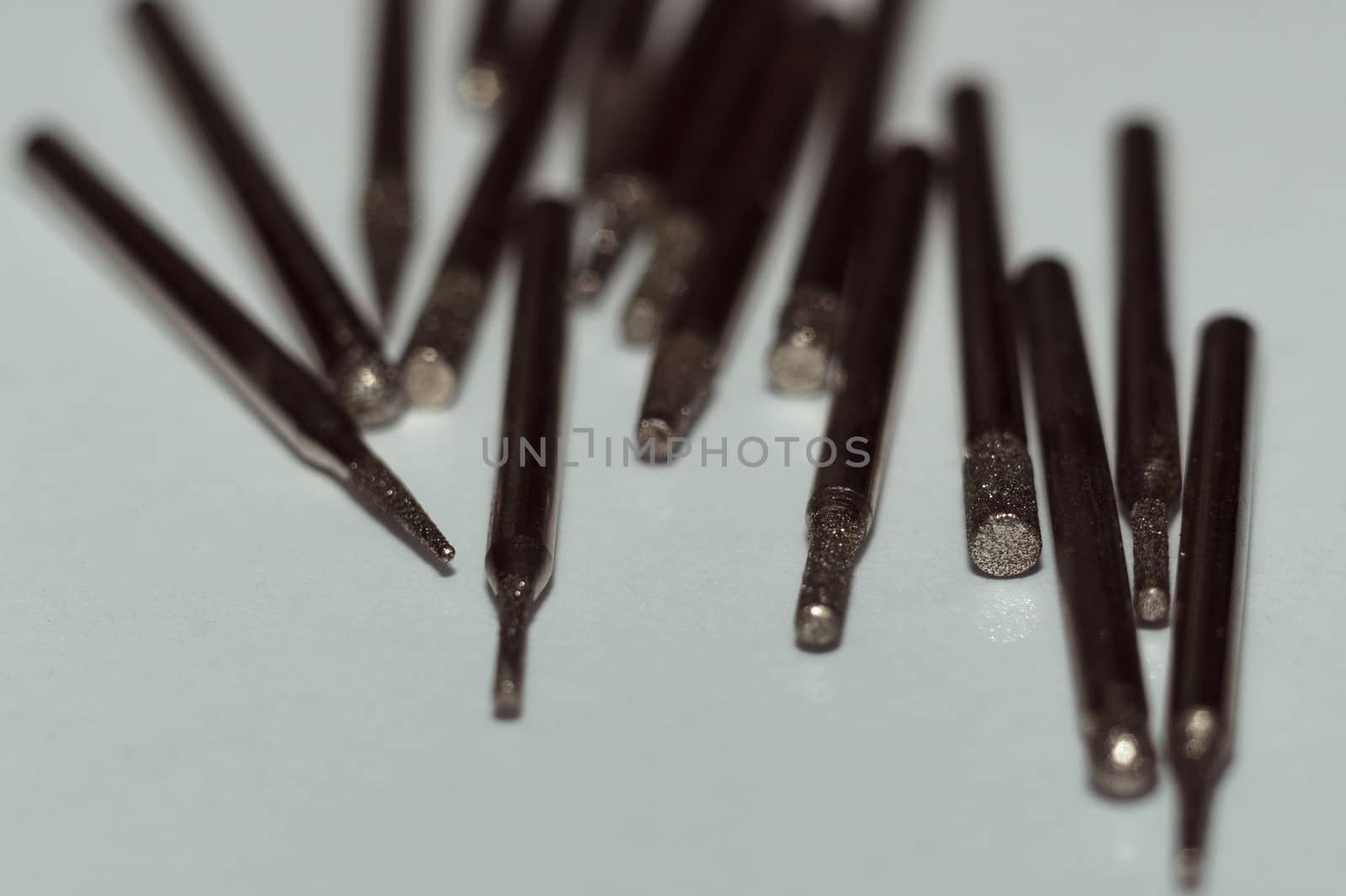 Diamond drill bits on white background. Close-up view. Tools jeweler and dentist.