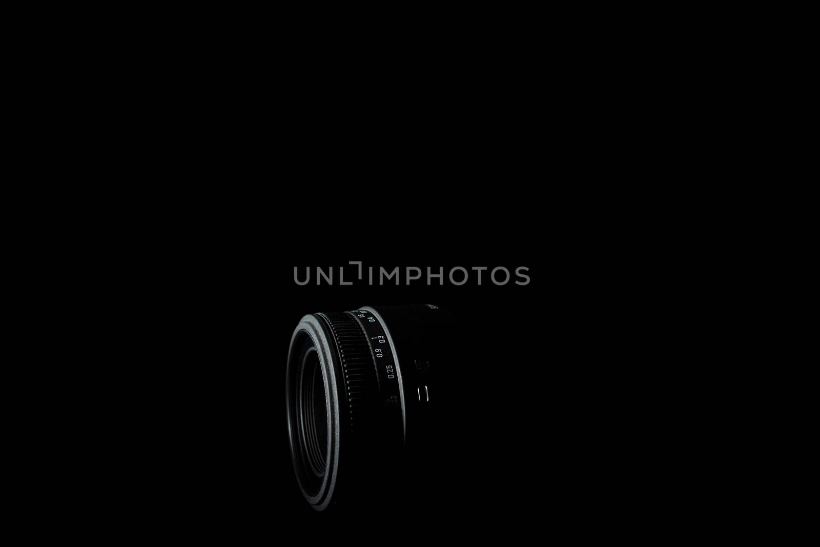 Underexposed photo of DSLR lens. Stock photo isolated on black background. Low light photo. A large depth of field.