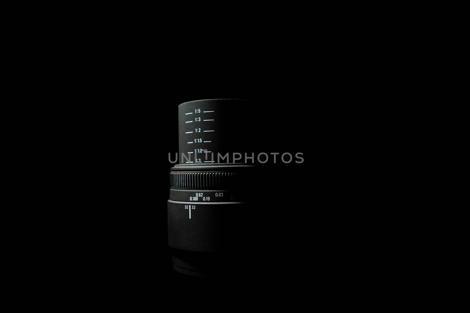 Underexposed photo of DSLR camera lens lying on black background. Stock photo isolated. Low light photo and large depth of field.