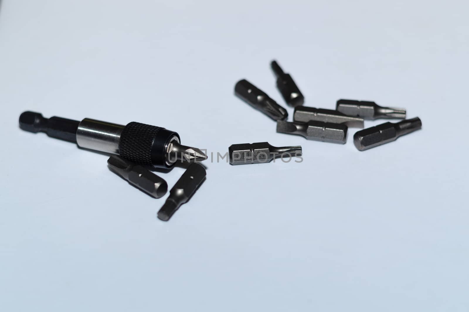Many tool bits with bitholder on white background.