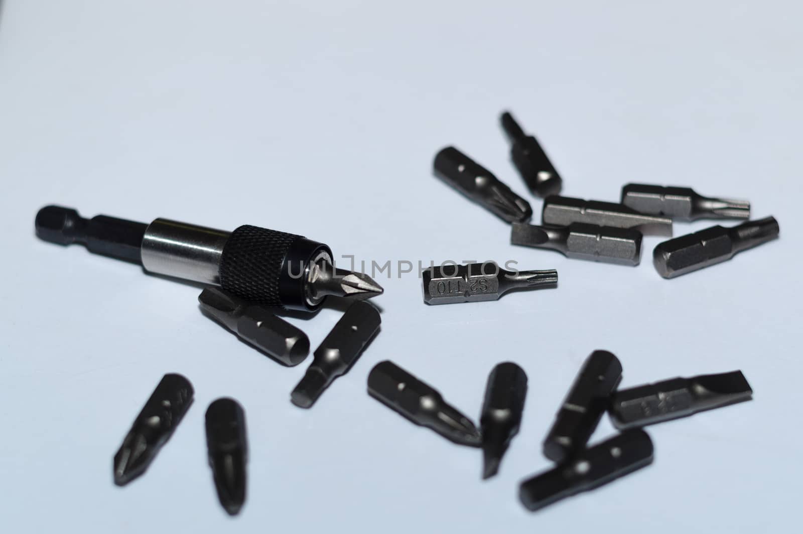 Many tool bits with bitholder on white background.