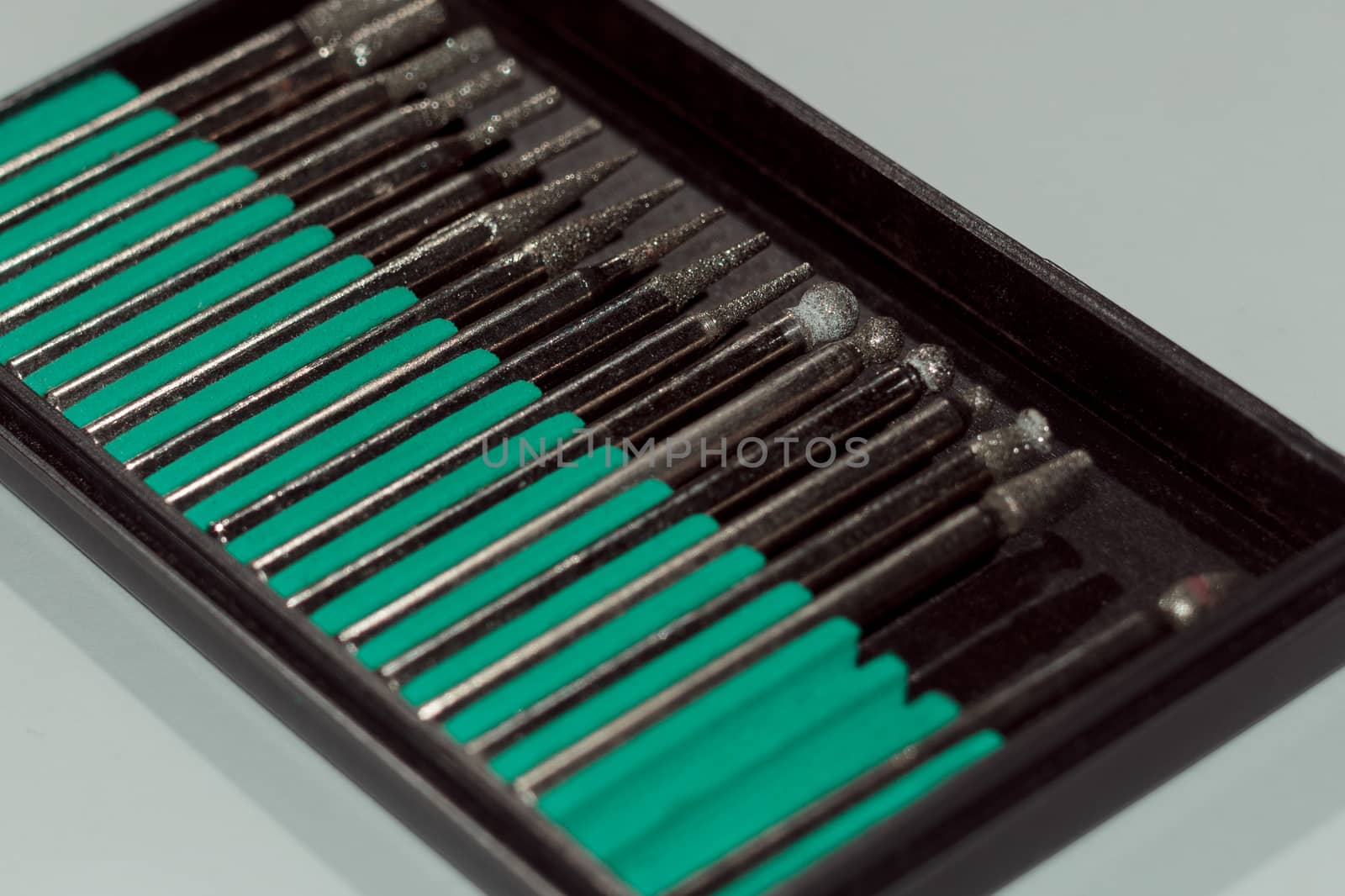 Diamond drill bits in black holder on white background