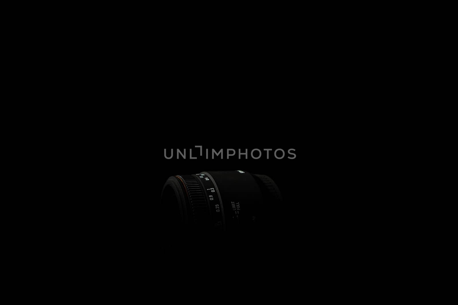 Underexposed photo of DSLR lens. Stock photo isolated on black background. Low light photo. A large depth of field.