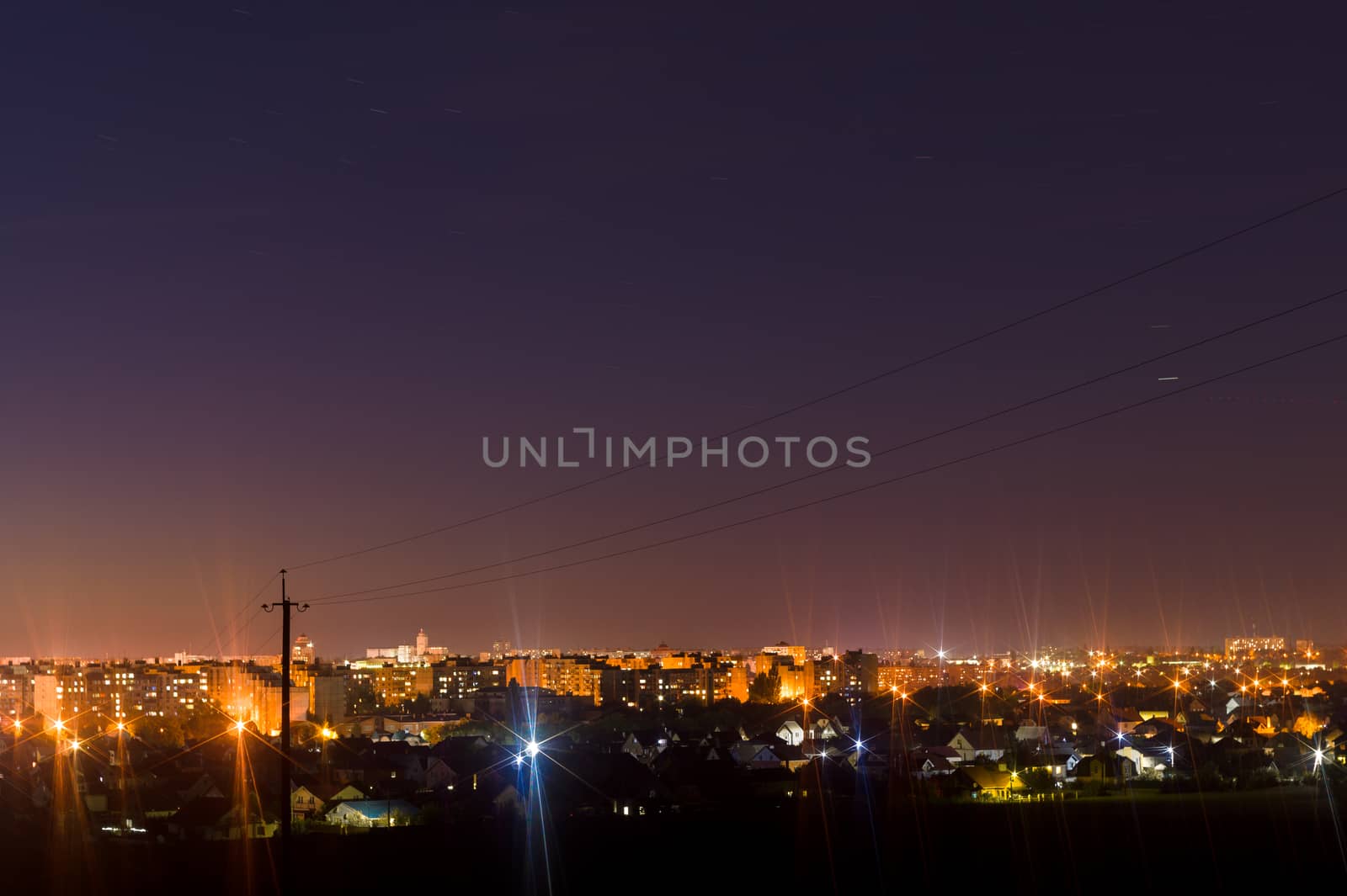 Long exposure night photo. A lot of stars with trees on foreground. Far from the city. Night landscape.