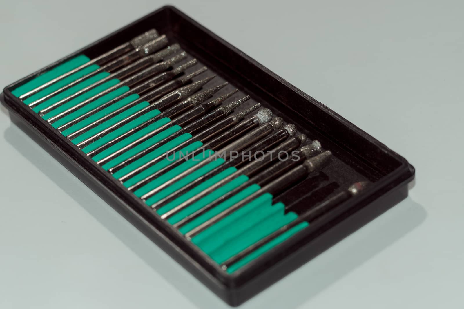 Diamond drill bits in black holder on white background by alexsdriver