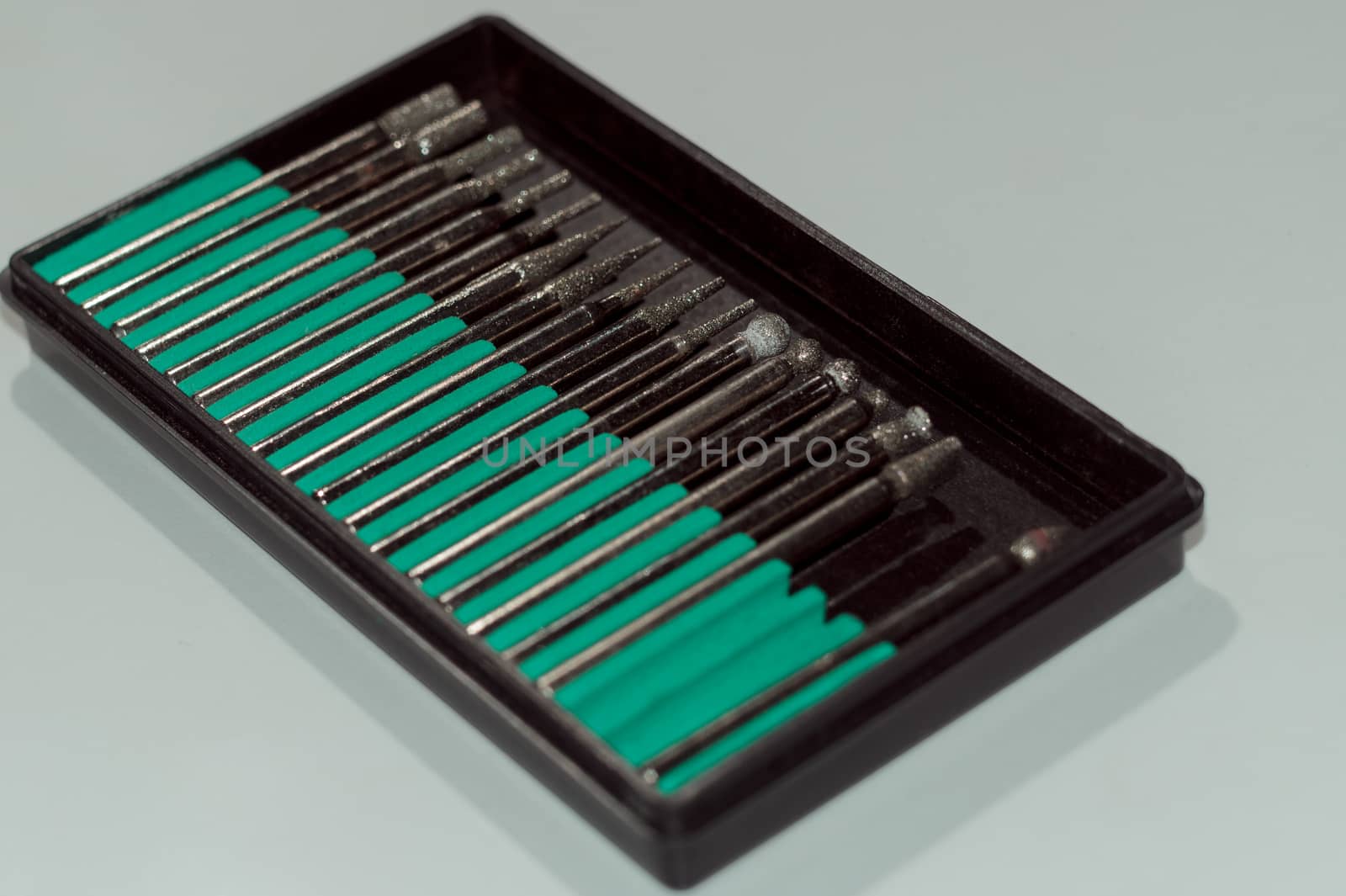 Diamond drill bits in black holder on white background