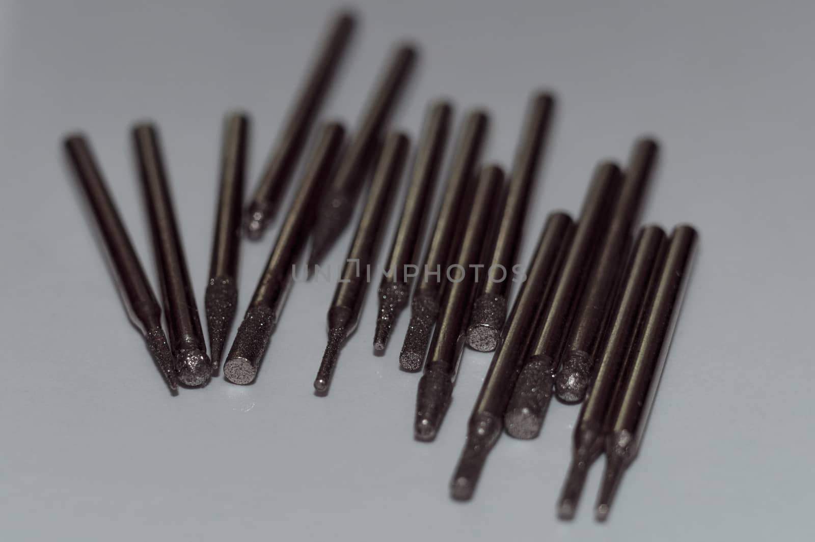 Diamond drill bits on white background. Close-up view. Tools jeweler and dentist. by alexsdriver