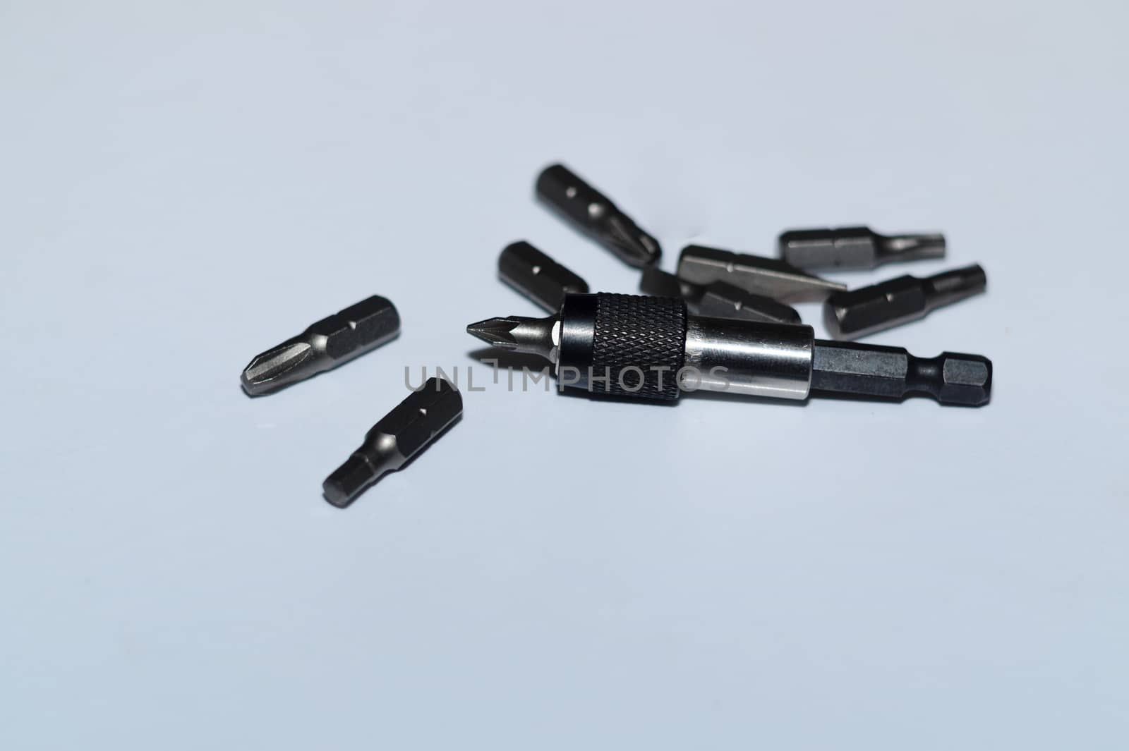 Many tool bits with bitholder on white background.
