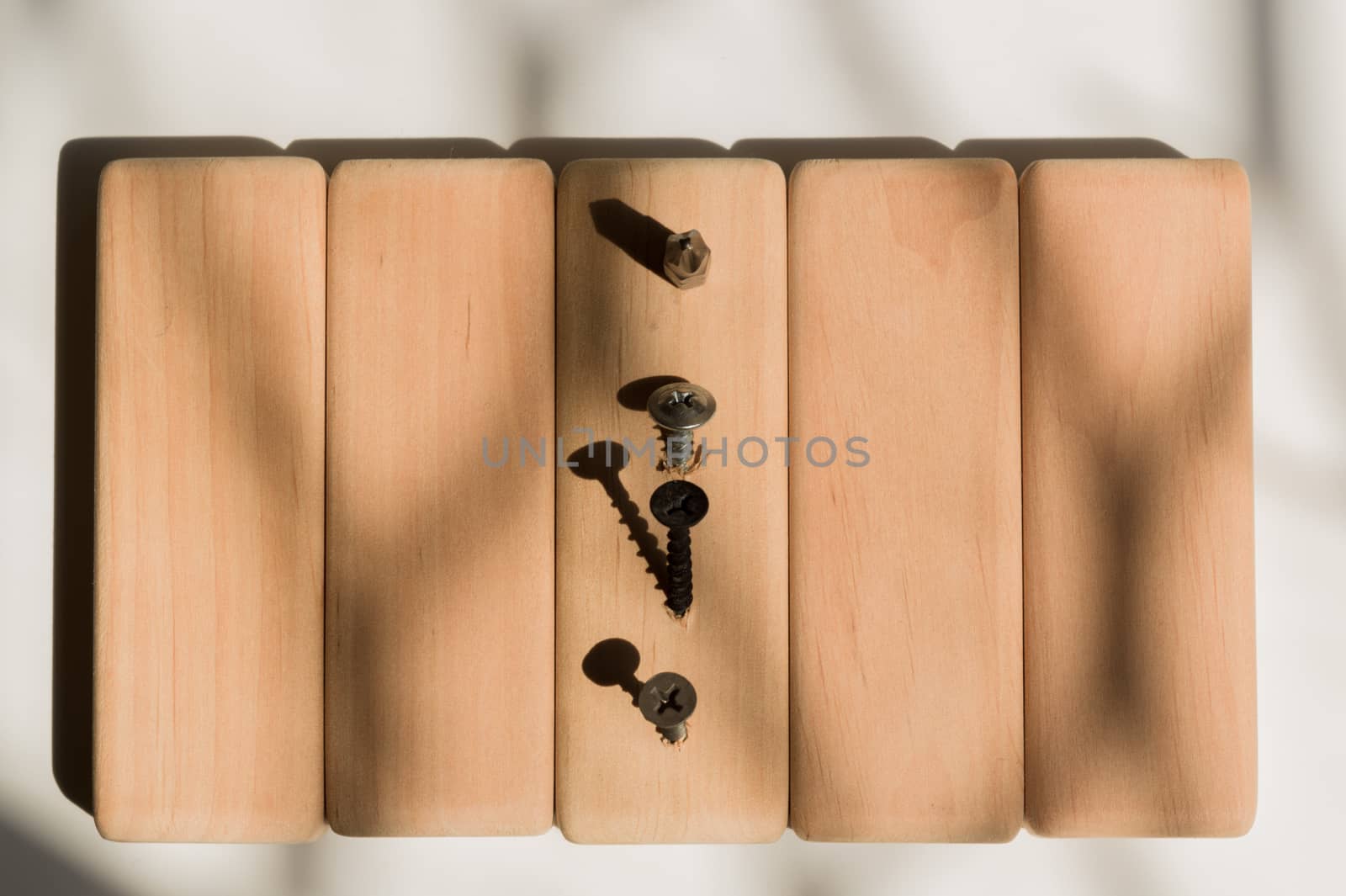 Learn the work with a screwdriver. Teaching to use tools. Conceptual photo. Bit for screwdriver and three screws- one silver and two black.ф