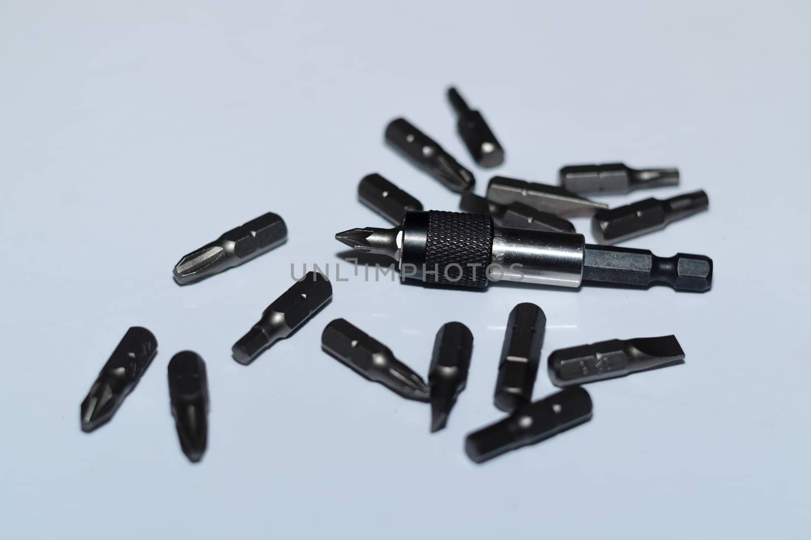 Many tool bits with bitholder on white background.