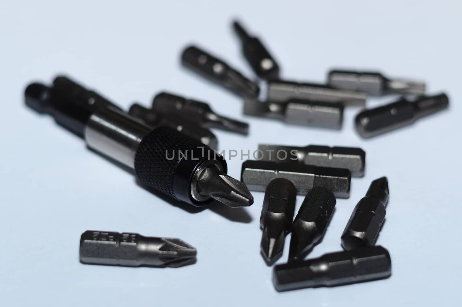 Many tool bits with bitholder on white background.