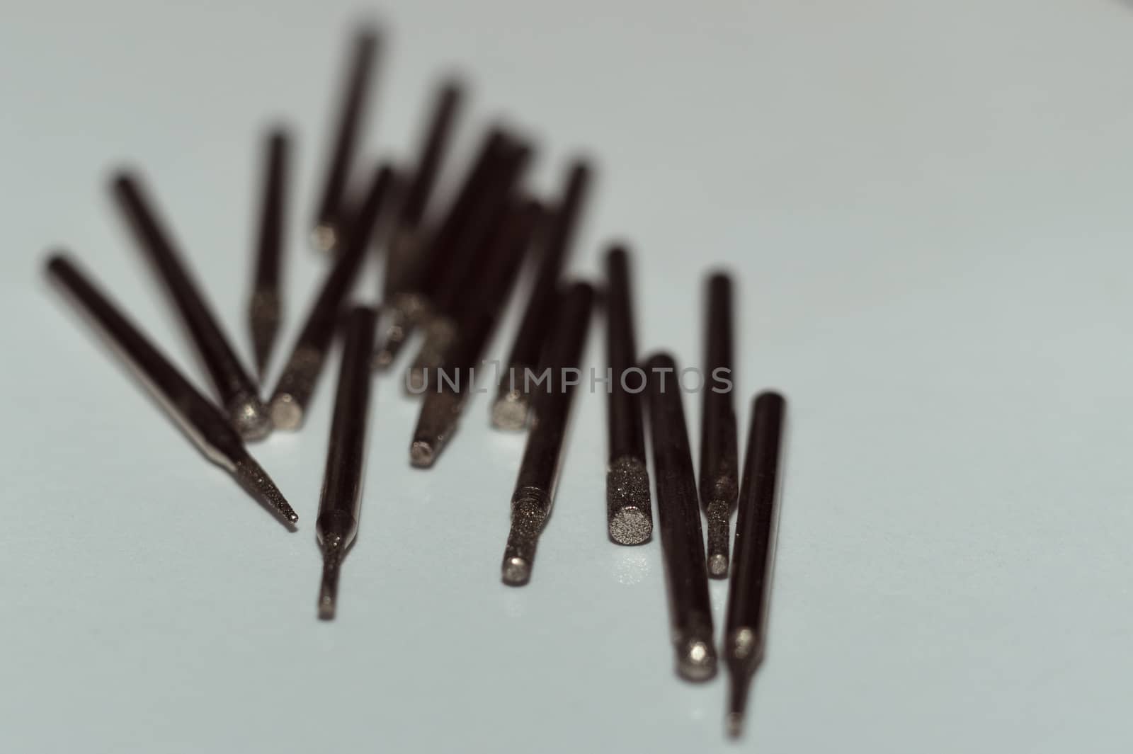 Diamond drill bits on white background. Close-up view. Tools jeweler and dentist. by alexsdriver