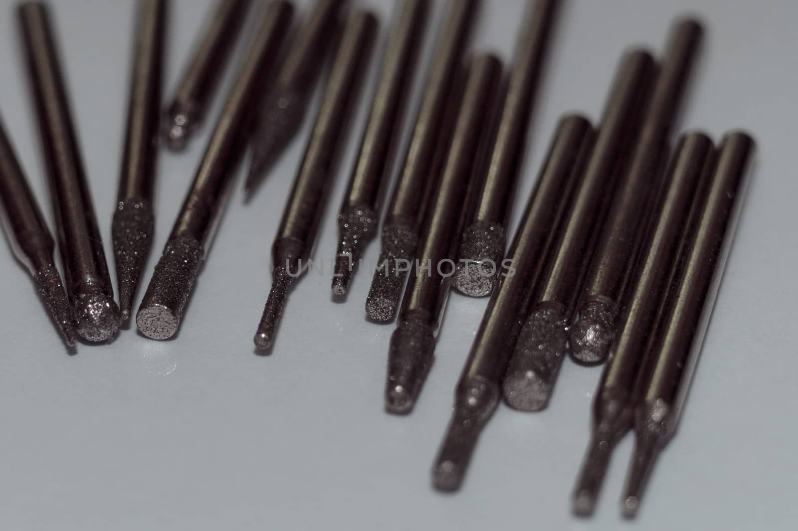 Diamond drill bits on white background. Close-up view. Tools jeweler and dentist.