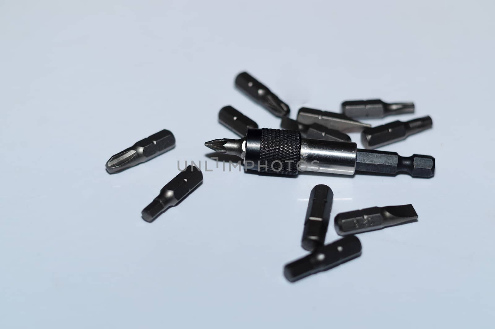 Many tool bits with bitholder on white background.