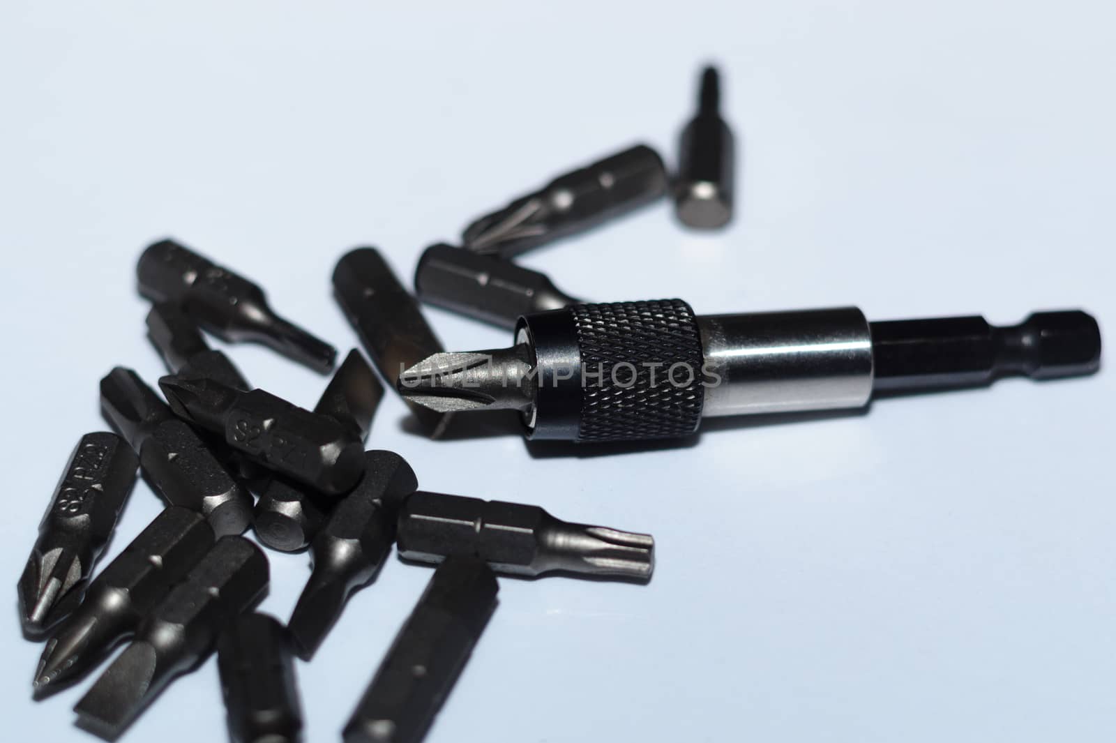 Many tool bits with bitholder on white background.