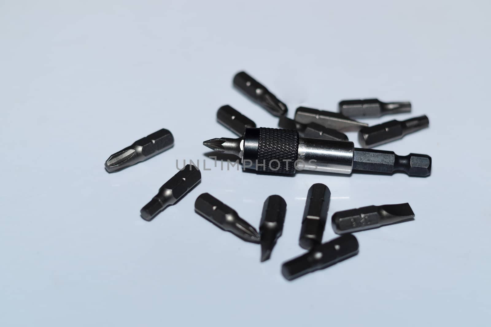 Many tool bits with bitholder on white background.