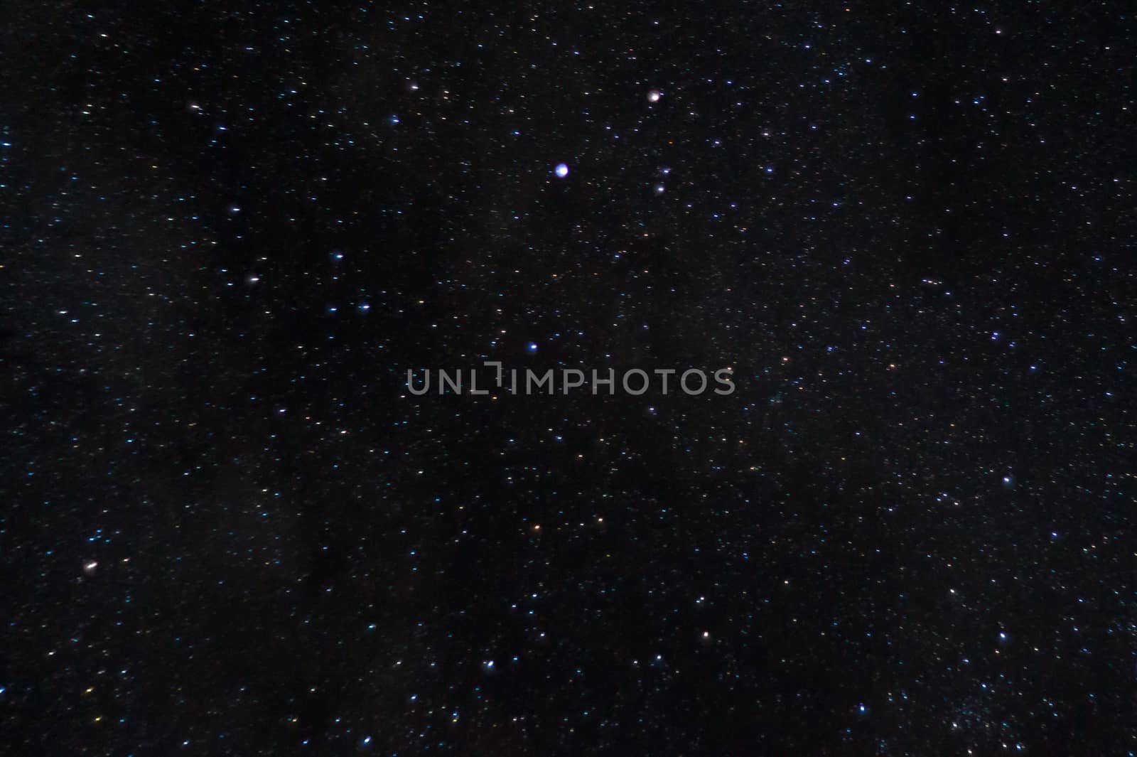 Long exposure night photo of a bright stars. A lot of stars with constellations. Far from the city. Night landscape.