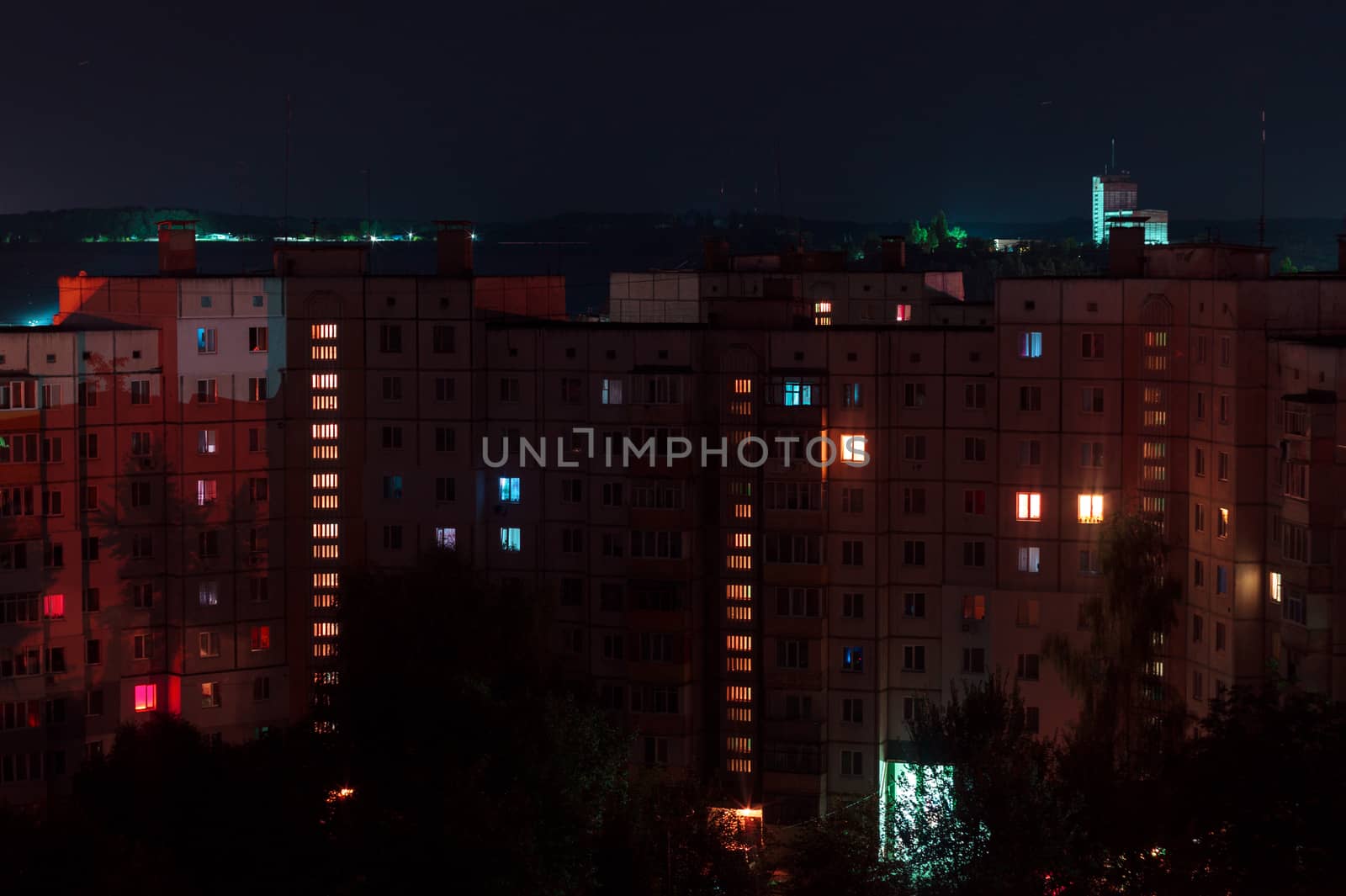 Night long exposure photo 9 and 10 floors high-rise buildings in red colours. Big city life is here!