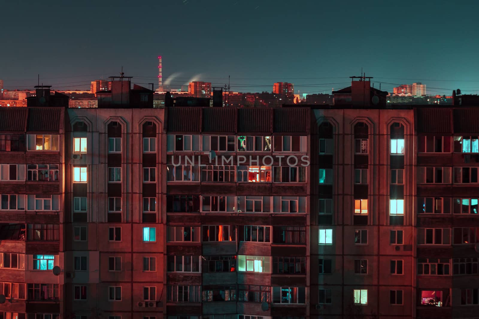 Night long exposure photo 9 and 10 floors high-rise buildings in red and blue colours. Big city life is here!