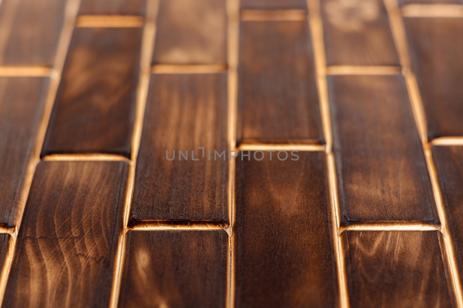 Wooden charred floor of small plates. Bottom view. Floor as an element of the interior.