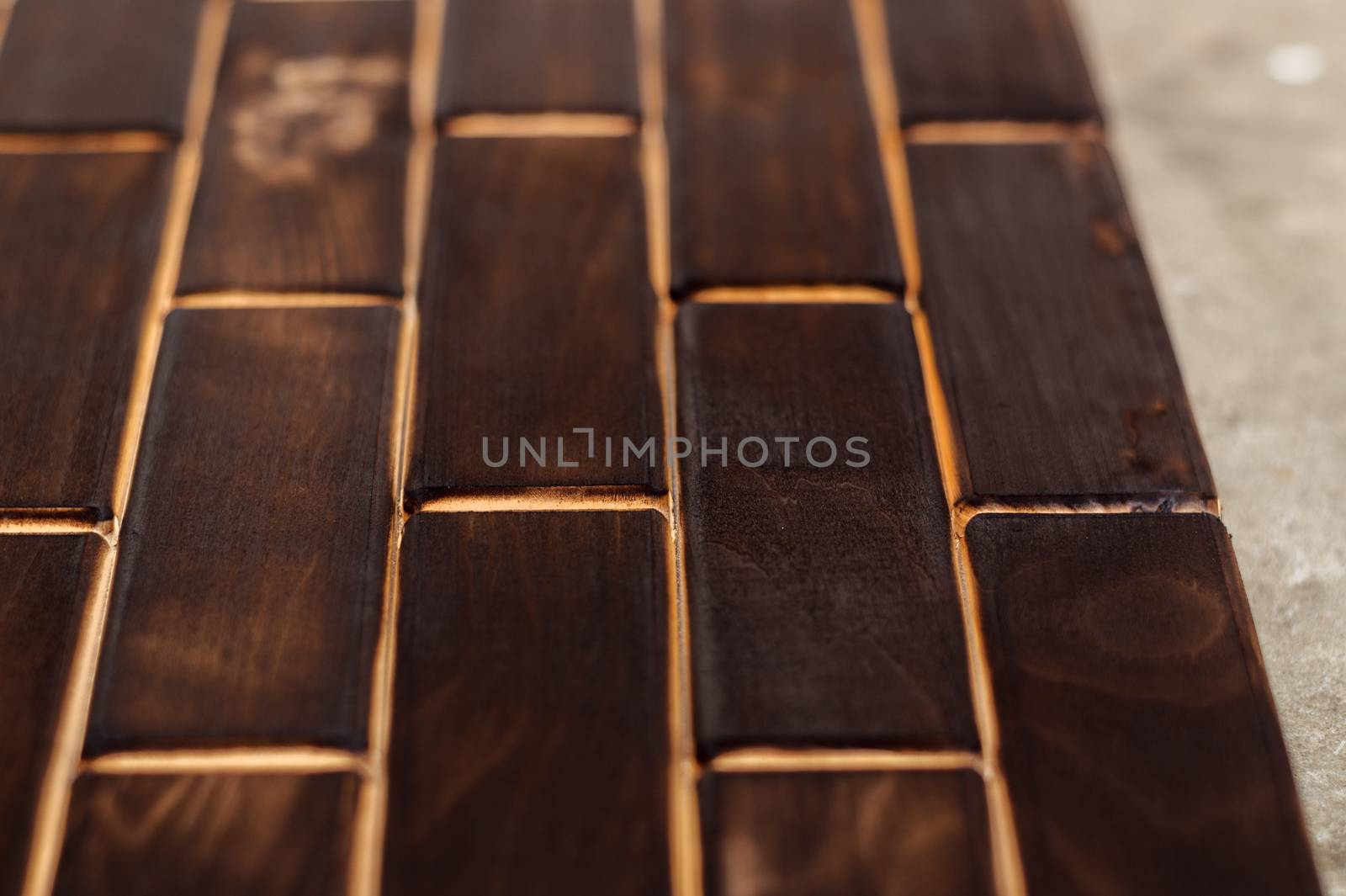 Wooden charred floor of small plates. Bottom view. Floor as an element of the interior.