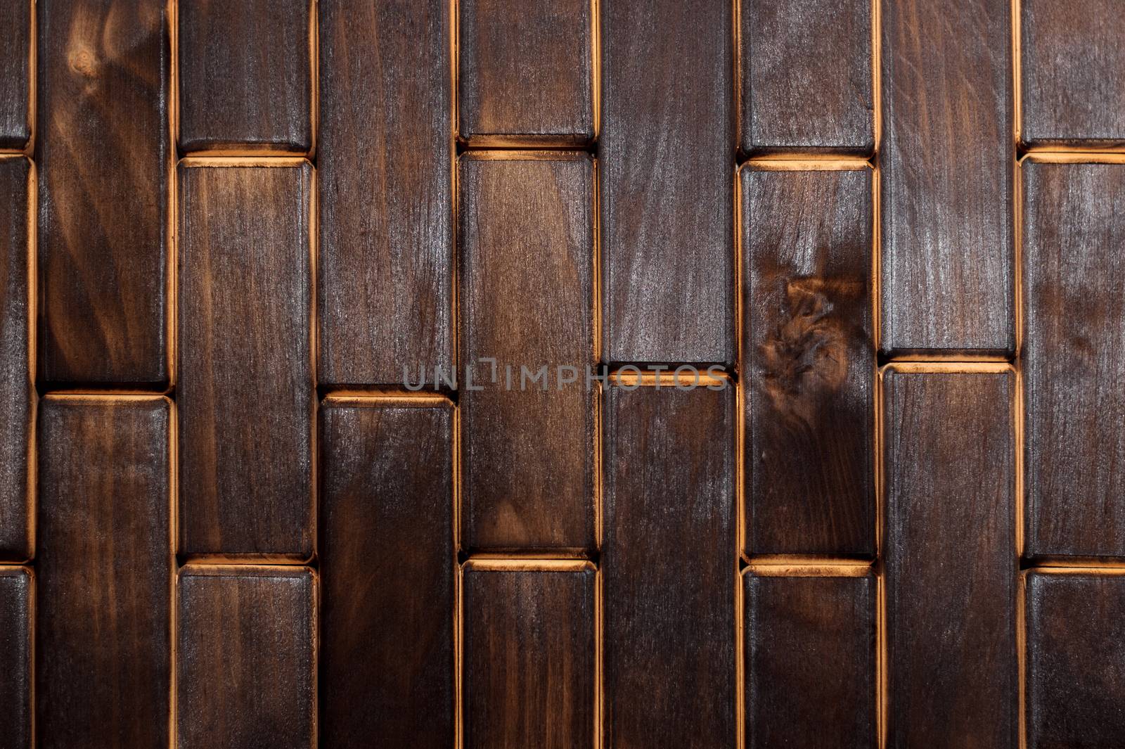 Wooden charred floor of small plates. View from above. Floor as an element of the interior.