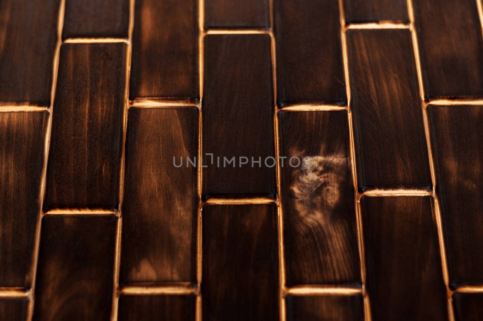 Wooden charred floor of small plates. Bottom view. Floor as an element of the interior.
