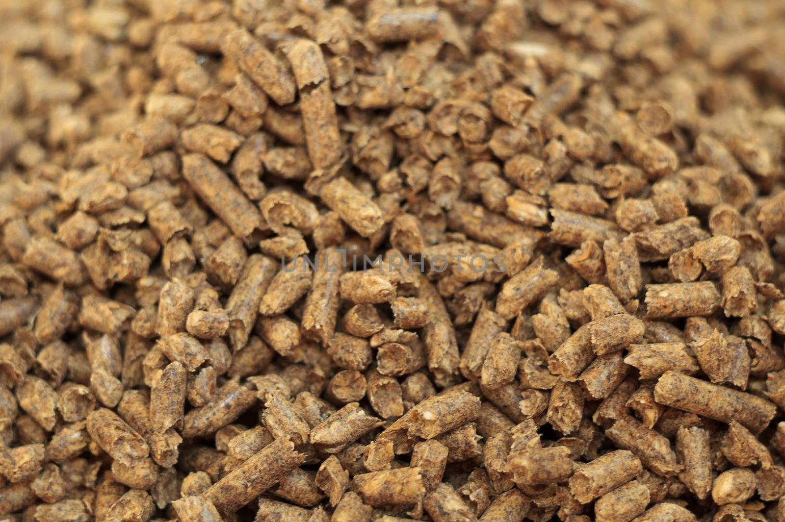 Fuel wood pellet close-up. A source of alternative clean energy. A lot of pellet. Natural fuel and energy of future.