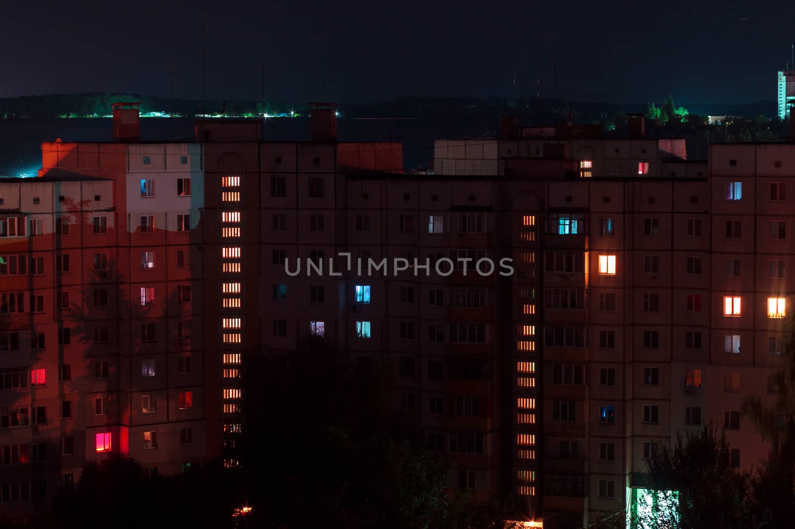 Night long exposure photo 9 and 10 floors high-rise buildings in red colours. Big city life is here!
